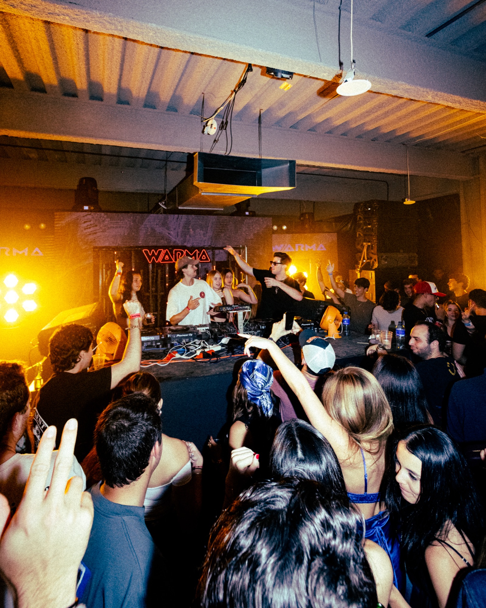 Crowd and artists inside a WARMA club session