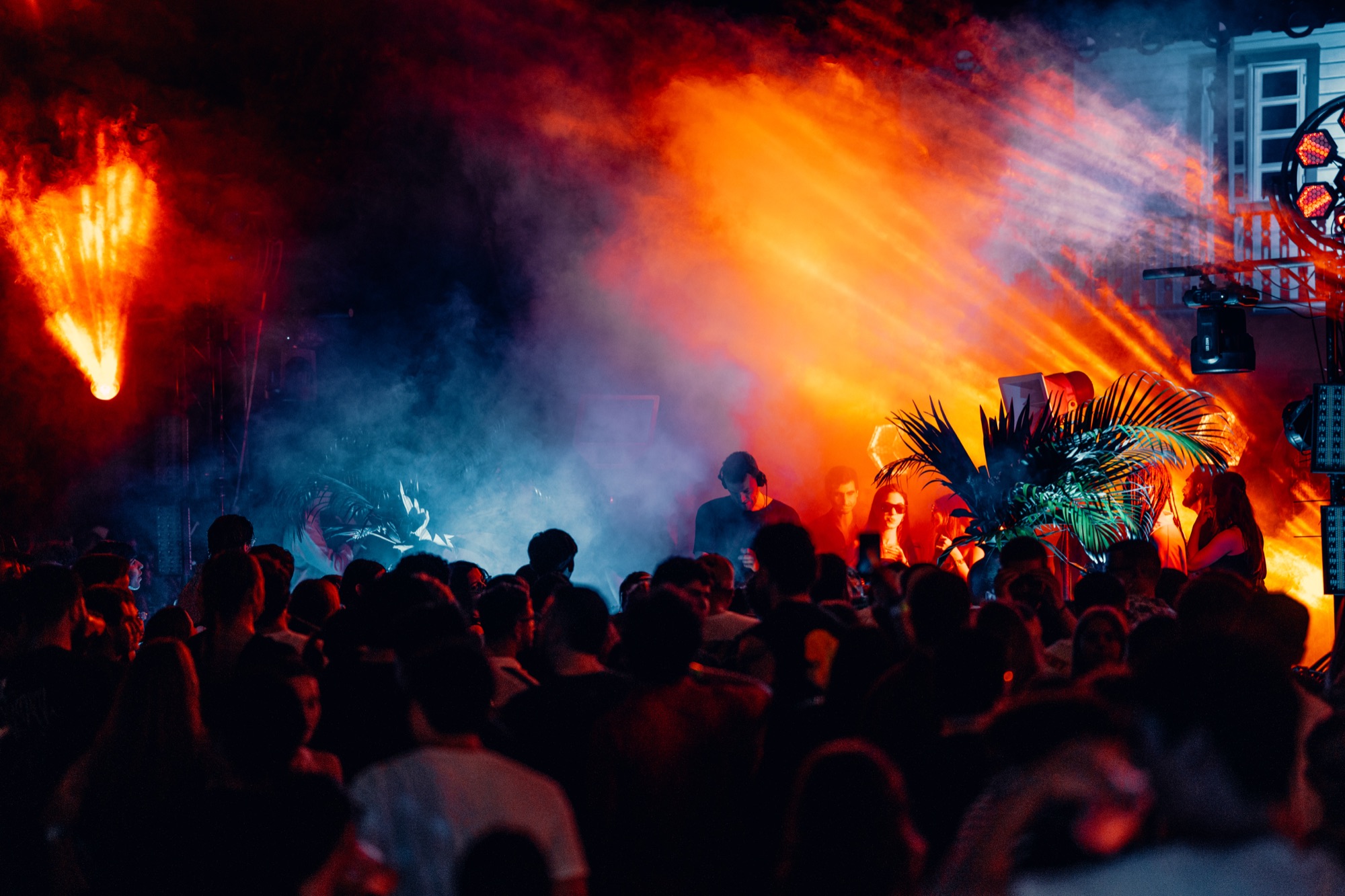 Packed WARMA dance floor under orange and blue lights